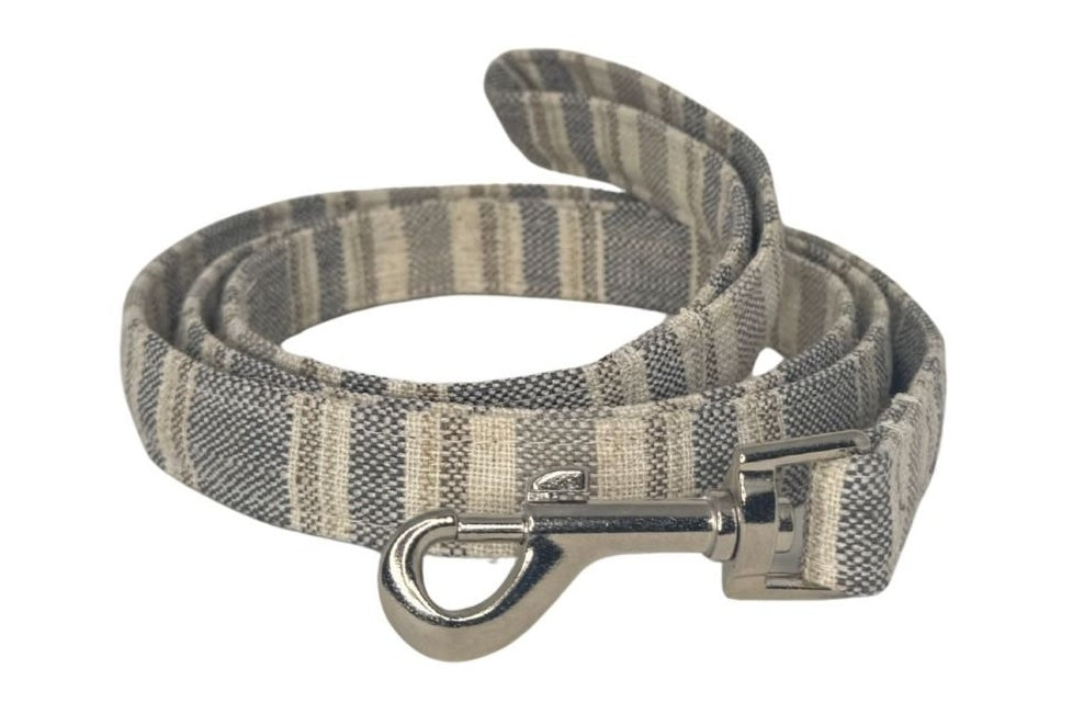 Striped dog leash with metal clip on a white background
