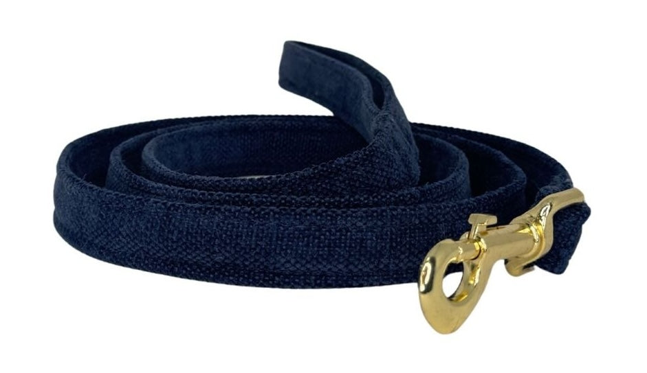 Navy blue dog leash with a gold clasp on a white background