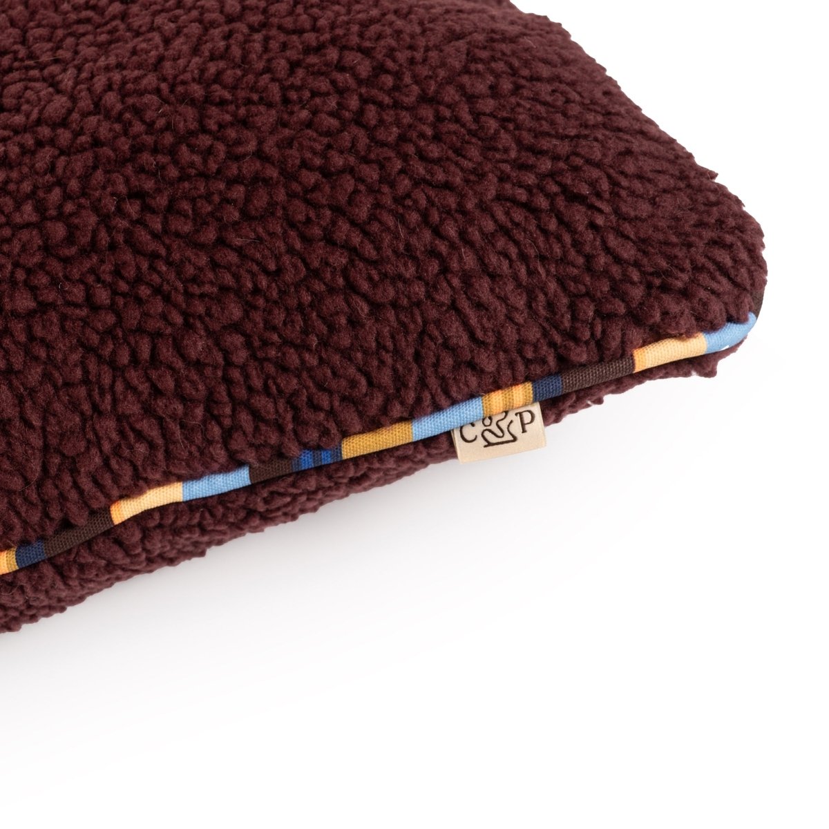 Brand Stripe Sherpa Pillow | Wine, close-up of sherpa and stripe cording