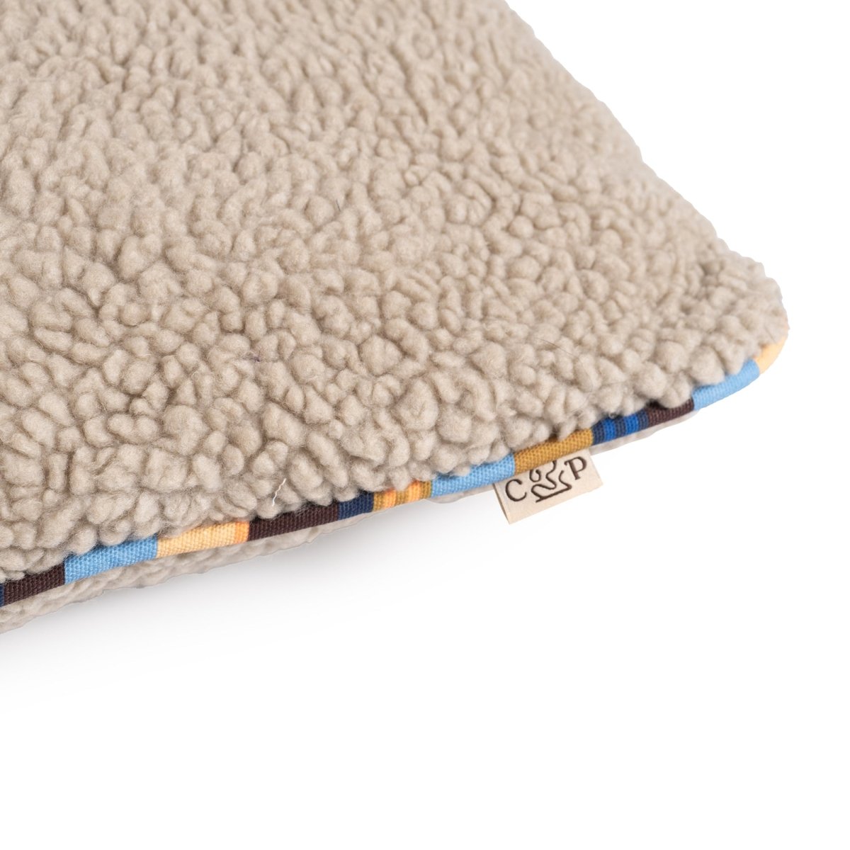 Brand Stripe Sherpa Pillow | Stone, close-up of sherpa and stripe cording